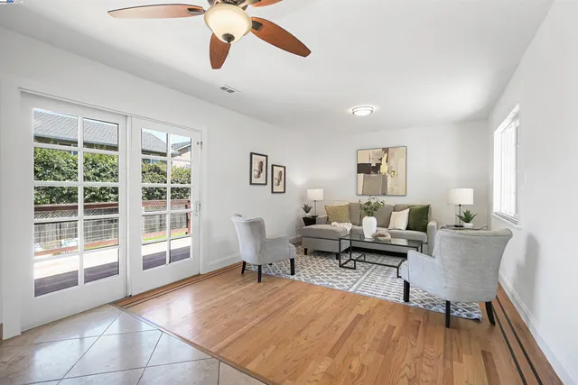 a bathroom with a toilet a sink a glass door a shower a mirror a vanity and window