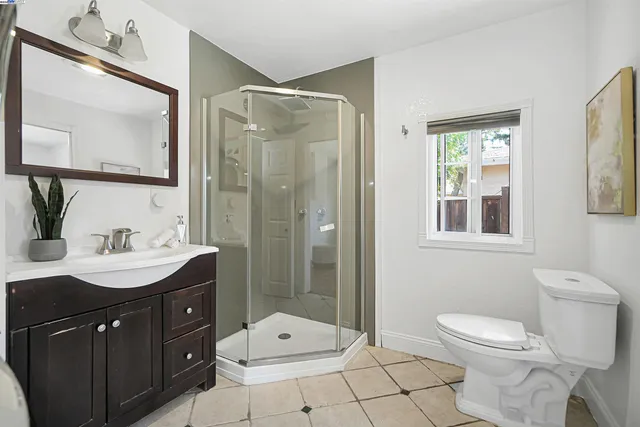 a room with a mirror and a potted plant