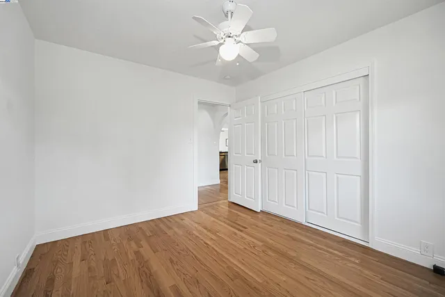 a view of balcony with wooden floor and fence