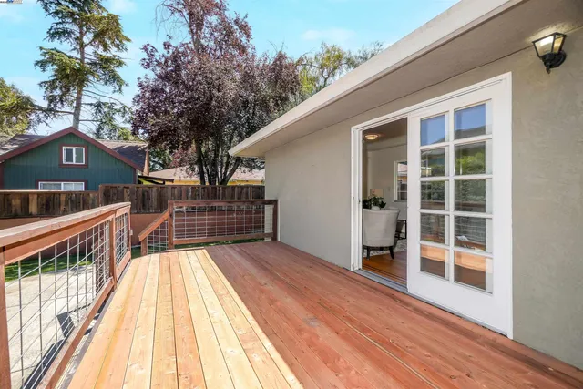 a view of a house with a small yard and wooden fence
