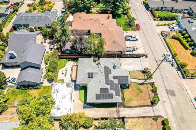 an aerial view of residential houses with yard