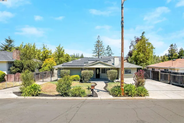 a view of a house with backyard porch and sitting area
