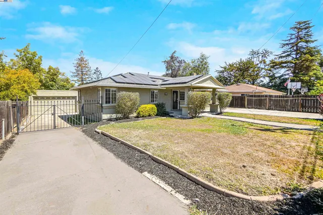 a view of a white house with a outdoor space