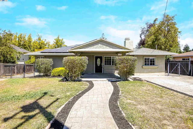 a view of a street with cars parked