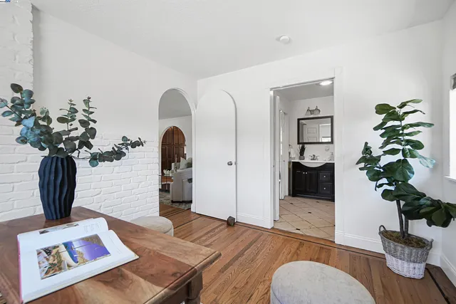 a living room with furniture and a potted plant