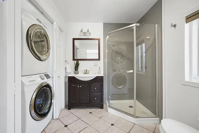 a view of a bathroom with sink washing machine and dryer