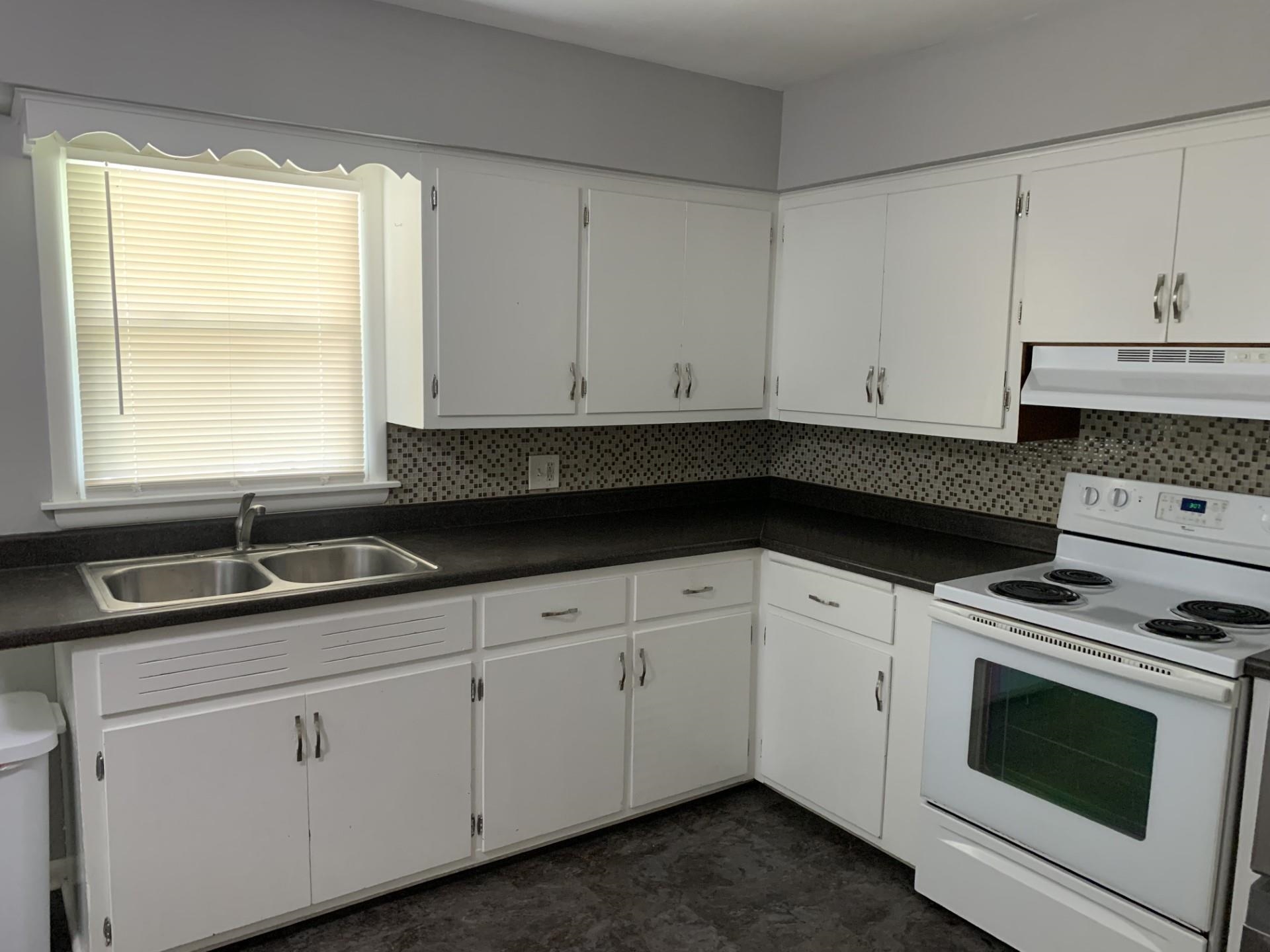 2020 Ridgeland Road Rockford, IL 61108 - Photo 8 of 19 a kitchen with granite countertop white cabinets and white appliances