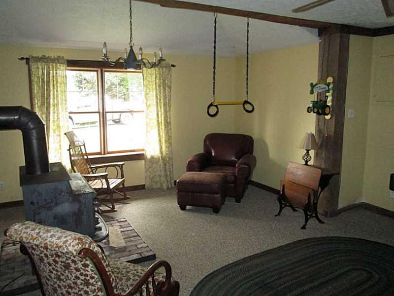 518 Iron Bridge Road Kittanning, PA 16201 - Photo 21 of 25 Family Room. Family room, finished in brick and barn wood. 31x18 with woodburner and built in bar, extra high ceilings as well.