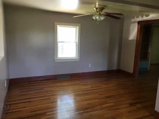 1882 Shutterlee Mill Road Staunton, VA 24401 - Photo 3 of 20 an empty room with wooden floor cabinet and windows