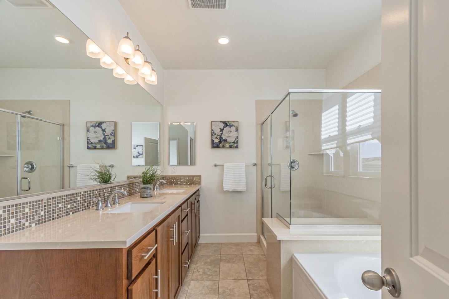38984 Primula Terrace Newark, CA 94560 - Photo 22 of 32 a spacious bathroom with a granite countertop sink a toilet a mirror and shower