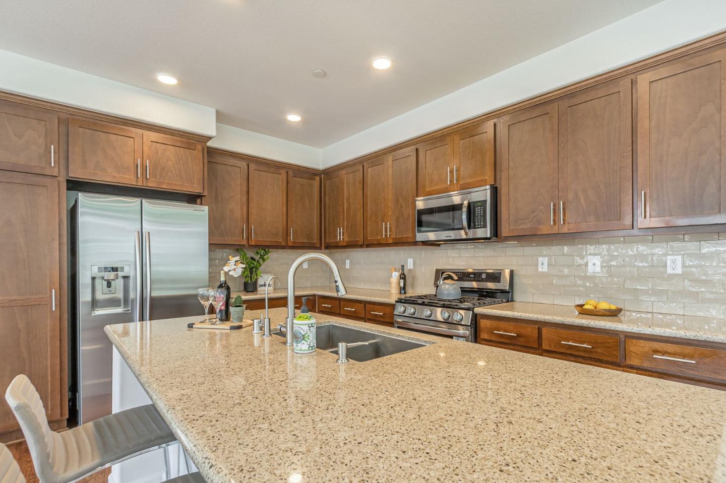 38984 Primula Terrace Newark, CA 94560 - Photo 7 of 32 a kitchen with stainless steel appliances granite countertop a sink refrigerator and microwave