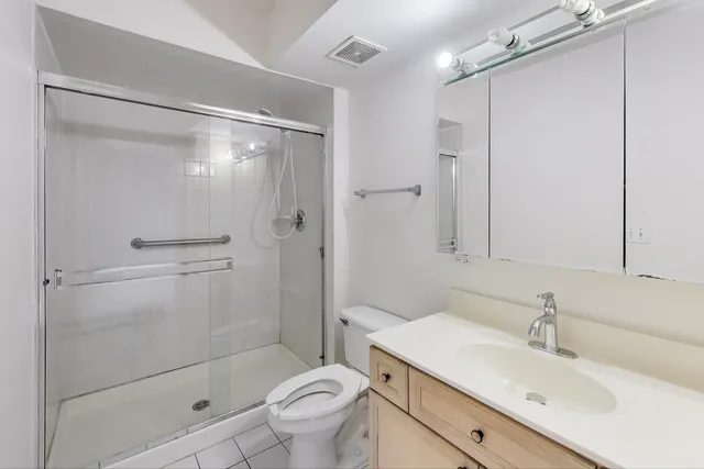 a bathroom with a sink a mirror and a shower