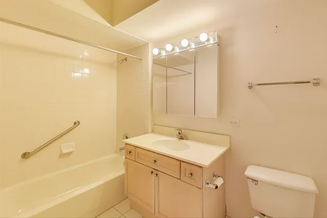 a bathroom with a sink a toilet and bathtub