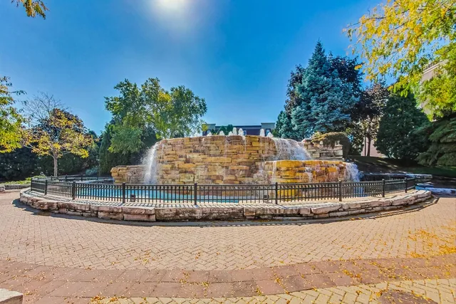 a street sign on a sidewalk next to a road