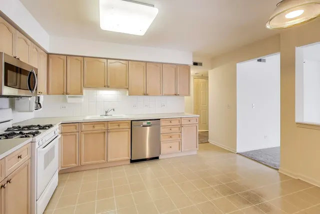 a kitchen with granite countertop a stove a sink and a granite counter tops