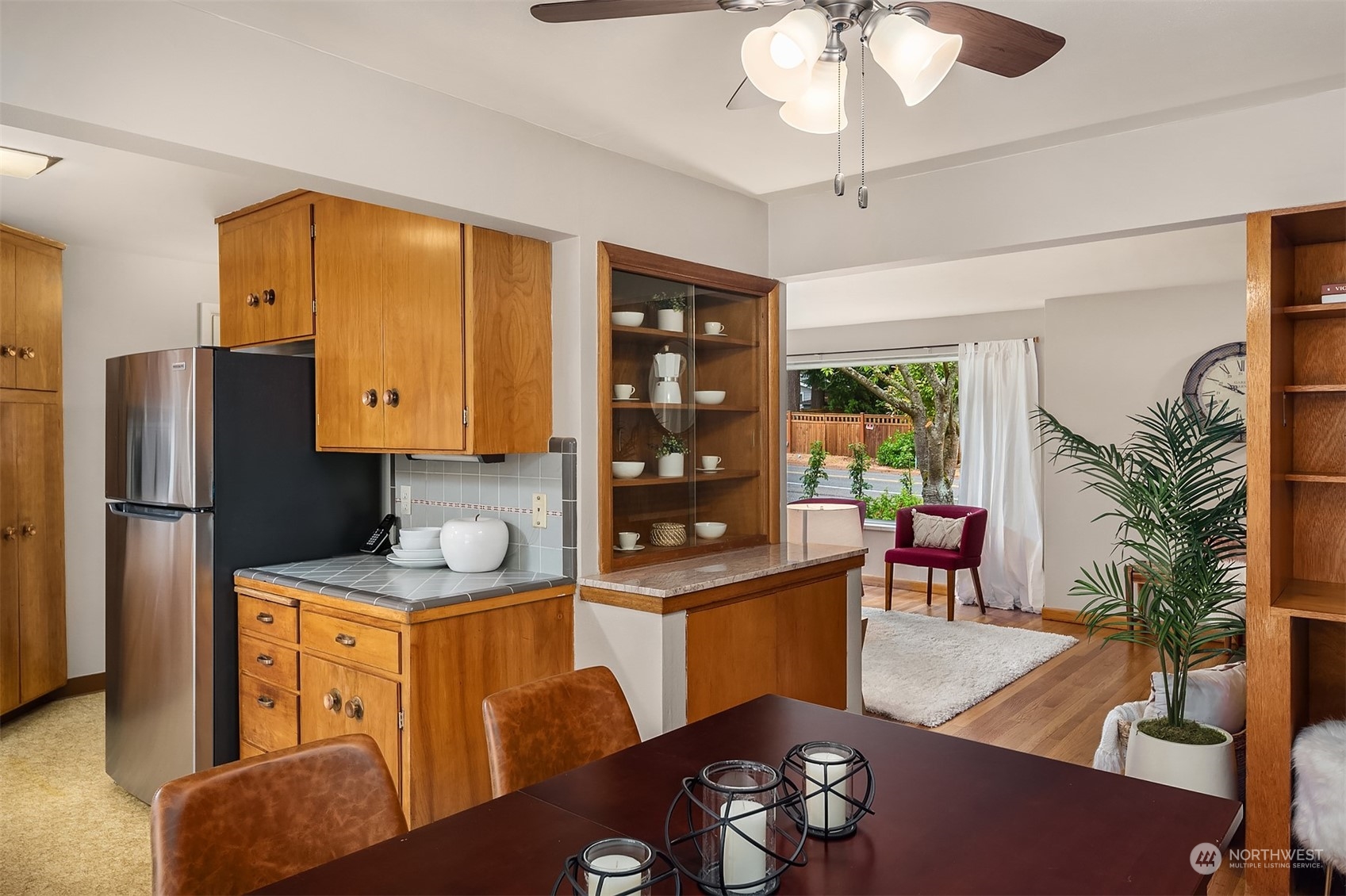 17512 Fremont Avenue North Shoreline, WA 98133 - Photo 12 of 35 a living room with stainless steel appliances granite countertop furniture a fireplace a rug and a window