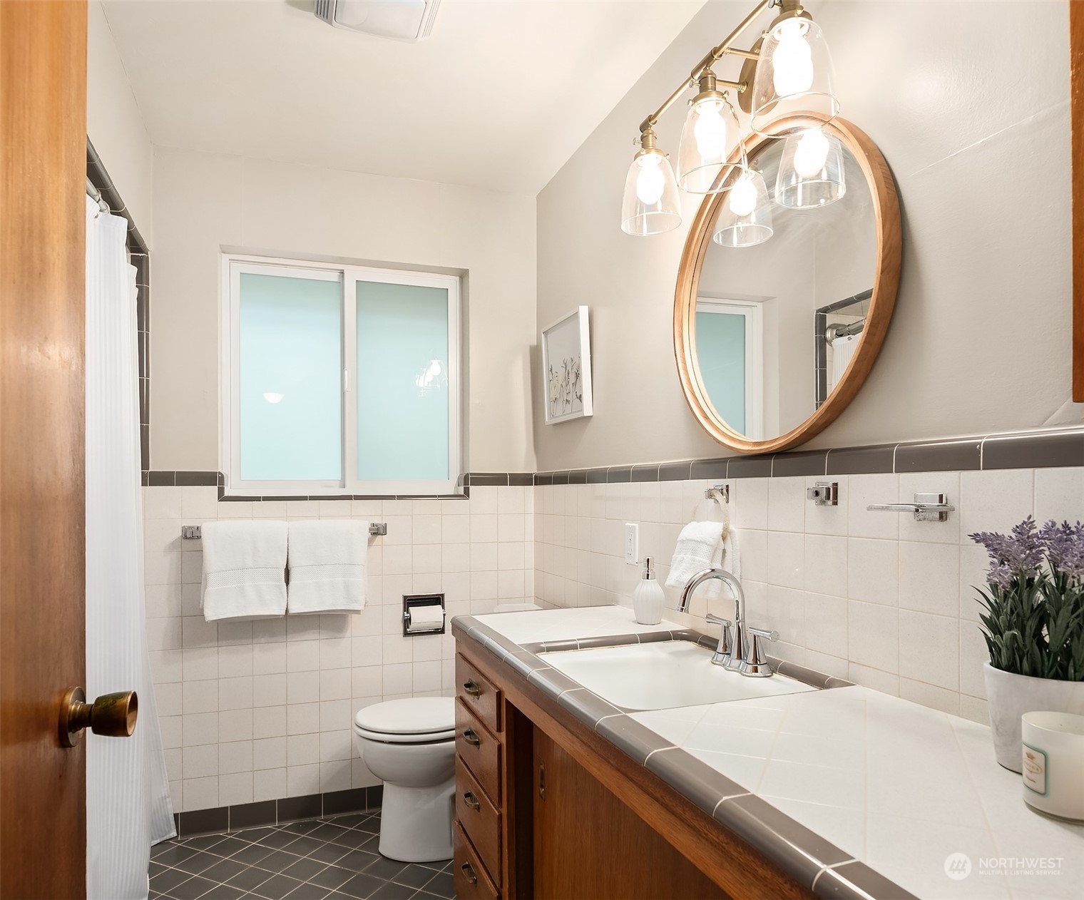 17512 Fremont Avenue North Shoreline, WA 98133 - Photo 13 of 35 a bathroom with a granite countertop sink and a mirror