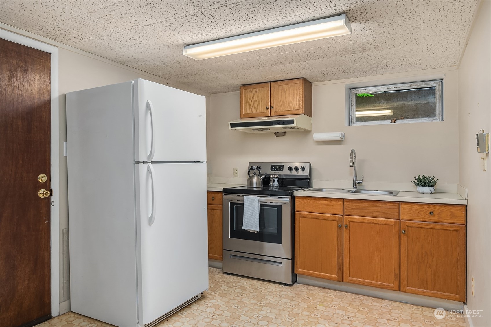 17512 Fremont Avenue North Shoreline, WA 98133 - Photo 21 of 35 a kitchen with stainless steel appliances granite countertop a refrigerator a stove a sink and a microwave