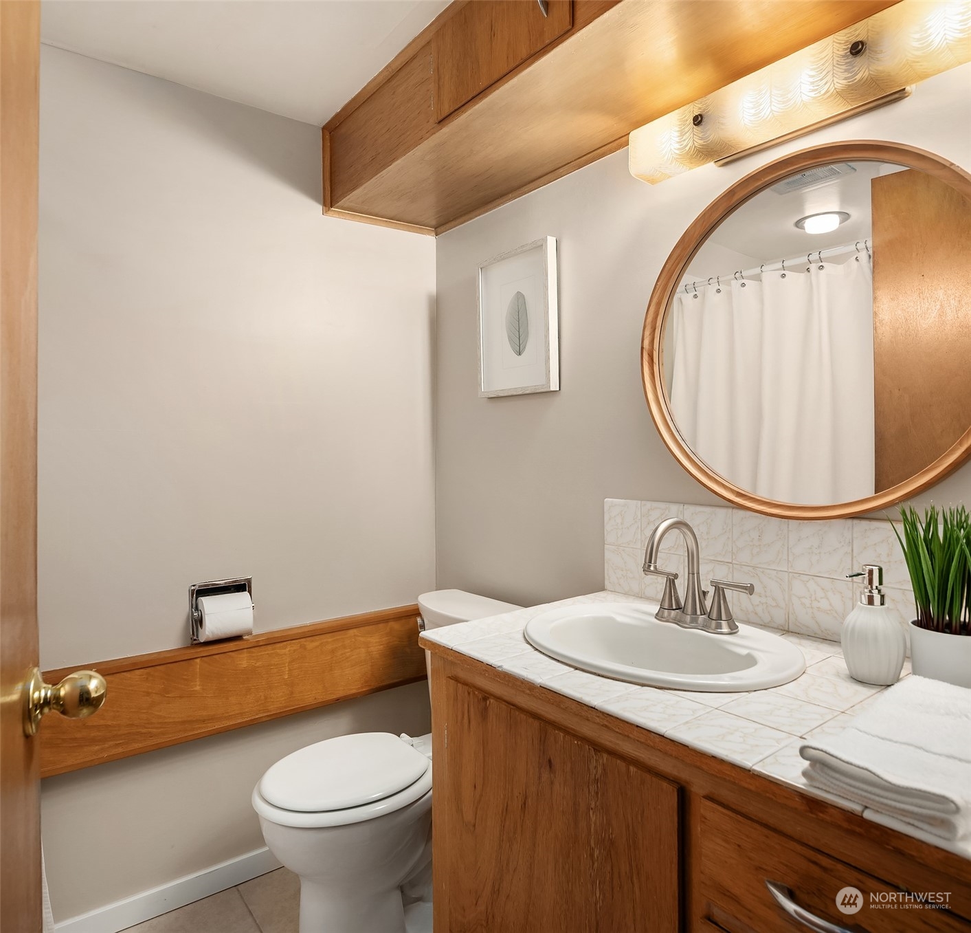 17512 Fremont Avenue North Shoreline, WA 98133 - Photo 23 of 35 a bathroom with a granite countertop sink a toilet and a mirror