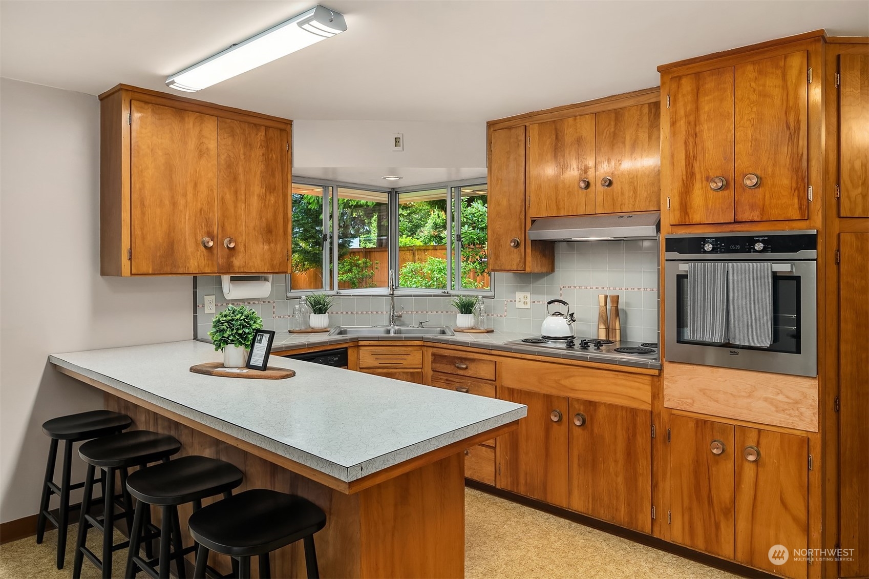 17512 Fremont Avenue North Shoreline, WA 98133 - Photo 8 of 35 a kitchen with stainless steel appliances a sink stove and cabinets