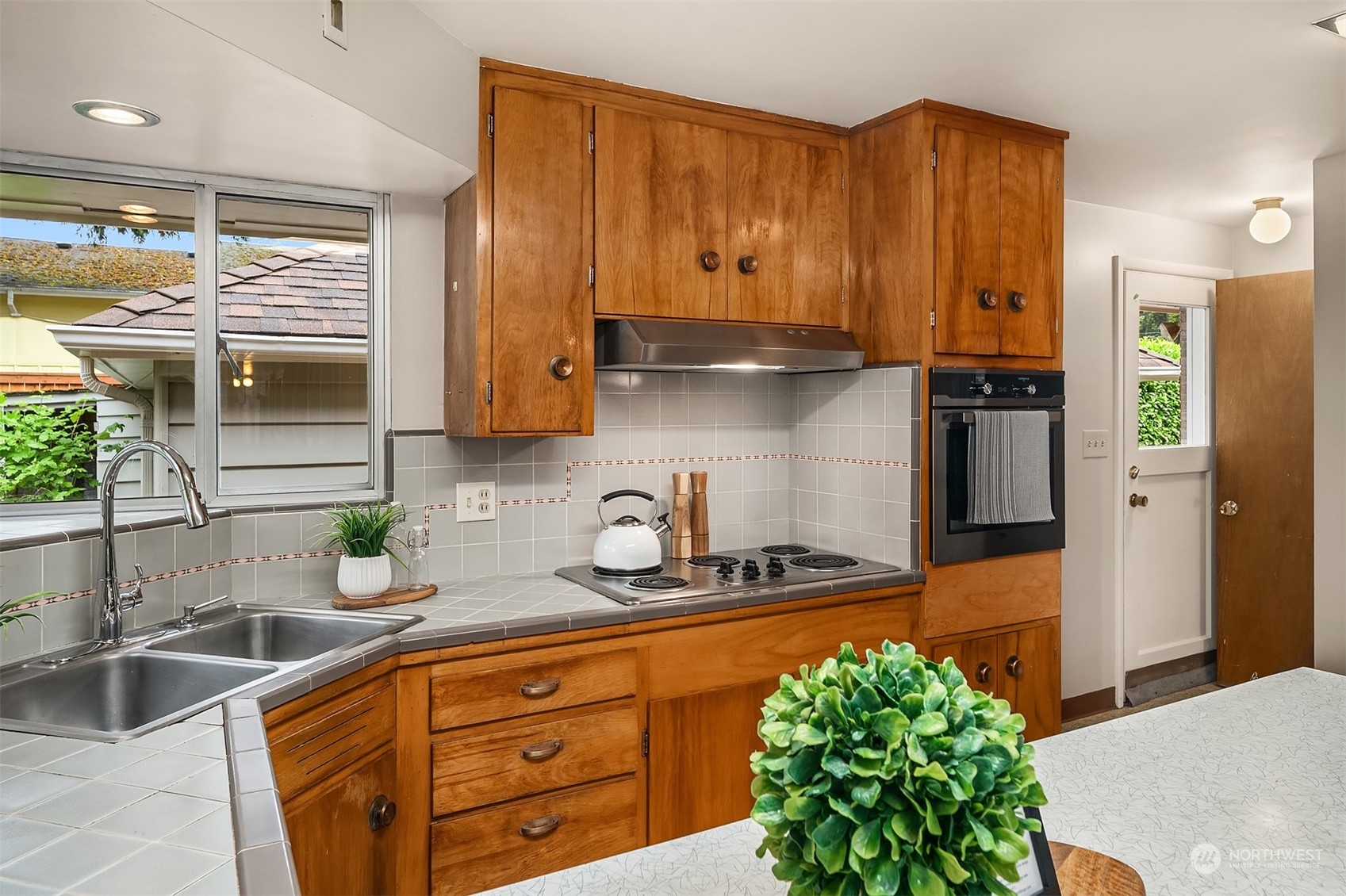 17512 Fremont Avenue North Shoreline, WA 98133 - Photo 10 of 35 a kitchen with stainless steel appliances granite countertop a sink stove and cabinets