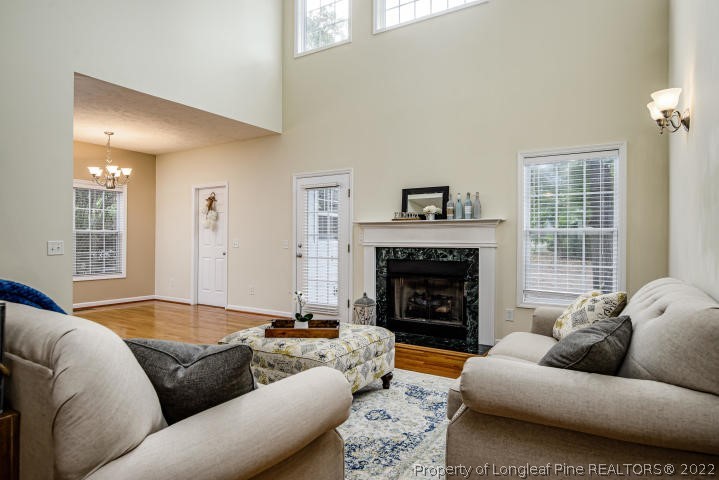 1065 Burning Tree Road Pinehurst, NC 28374 - Photo 4 of 29 a living room with furniture and a fireplace