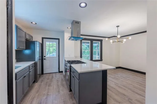 a kitchen with stainless steel appliances granite countertop a sink stove and cabinets