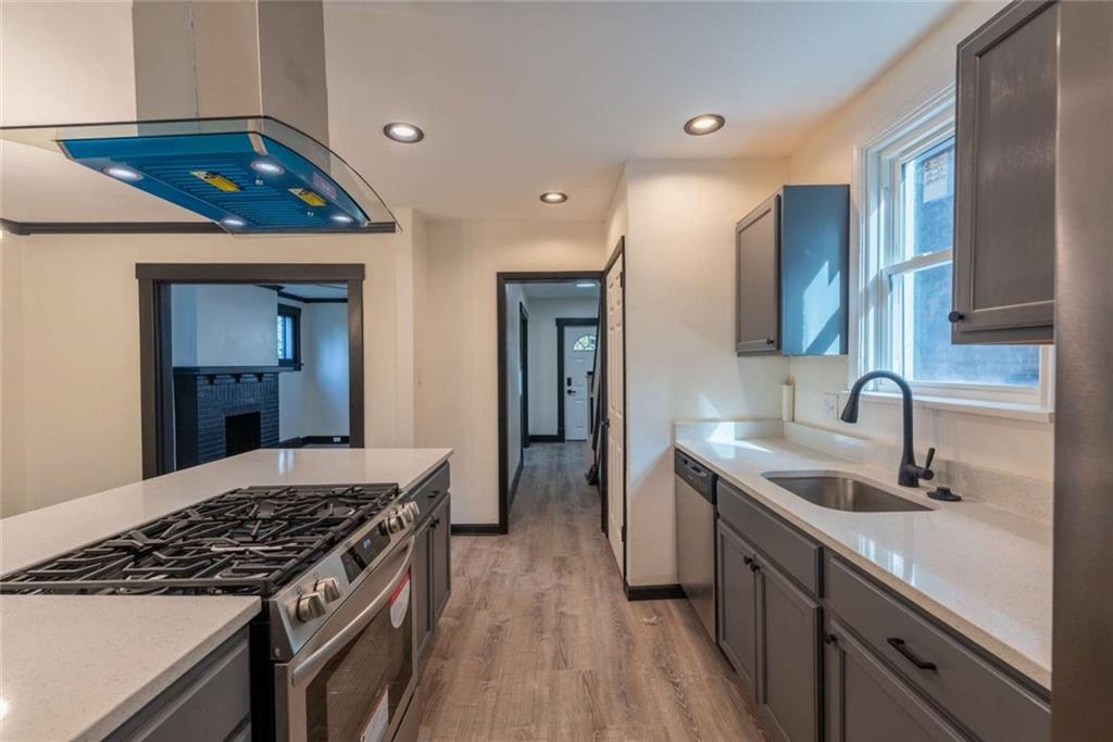 619 Barclay Avenue Pittsburgh, PA 15221 - Photo 12 of 23 a kitchen with stainless steel appliances granite countertop a sink stove and cabinets