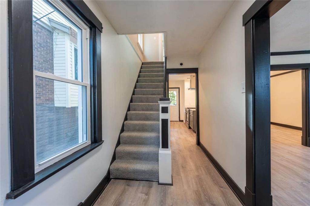 619 Barclay Avenue Pittsburgh, PA 15221 - Photo 13 of 23 a view of a hallway with wooden floor and windows