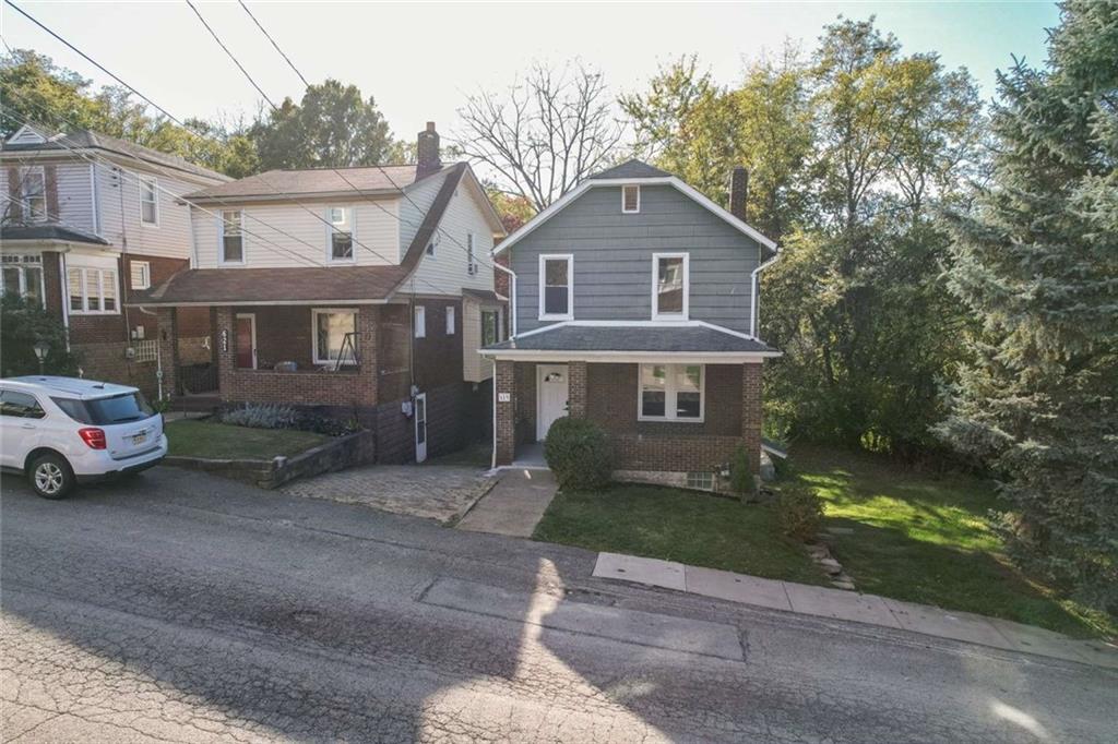 619 Barclay Avenue Pittsburgh, PA 15221 - Photo 23 of 23 a front view of a house with a yard