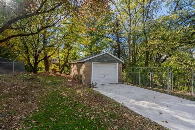 a view of a house with a tree in front of it