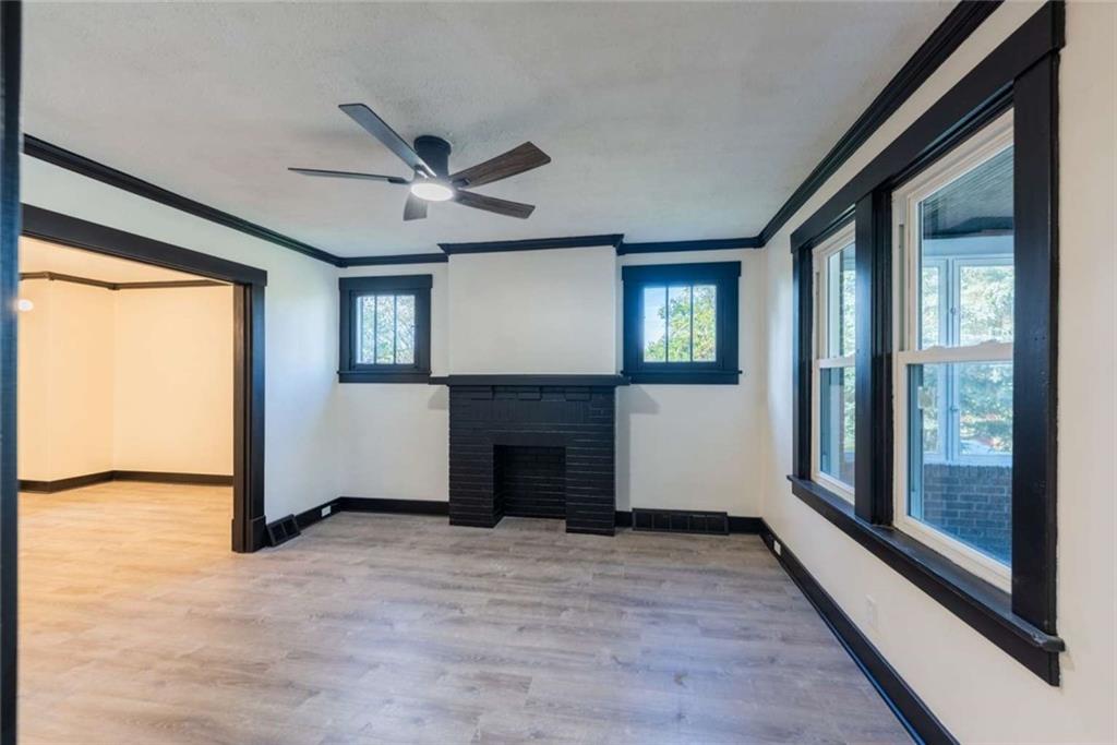 619 Barclay Avenue Pittsburgh, PA 15221 - Photo 7 of 23 a view of an empty room with a fireplace and a window
