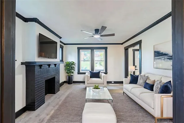 a living room with furniture a fireplace and a flat screen tv