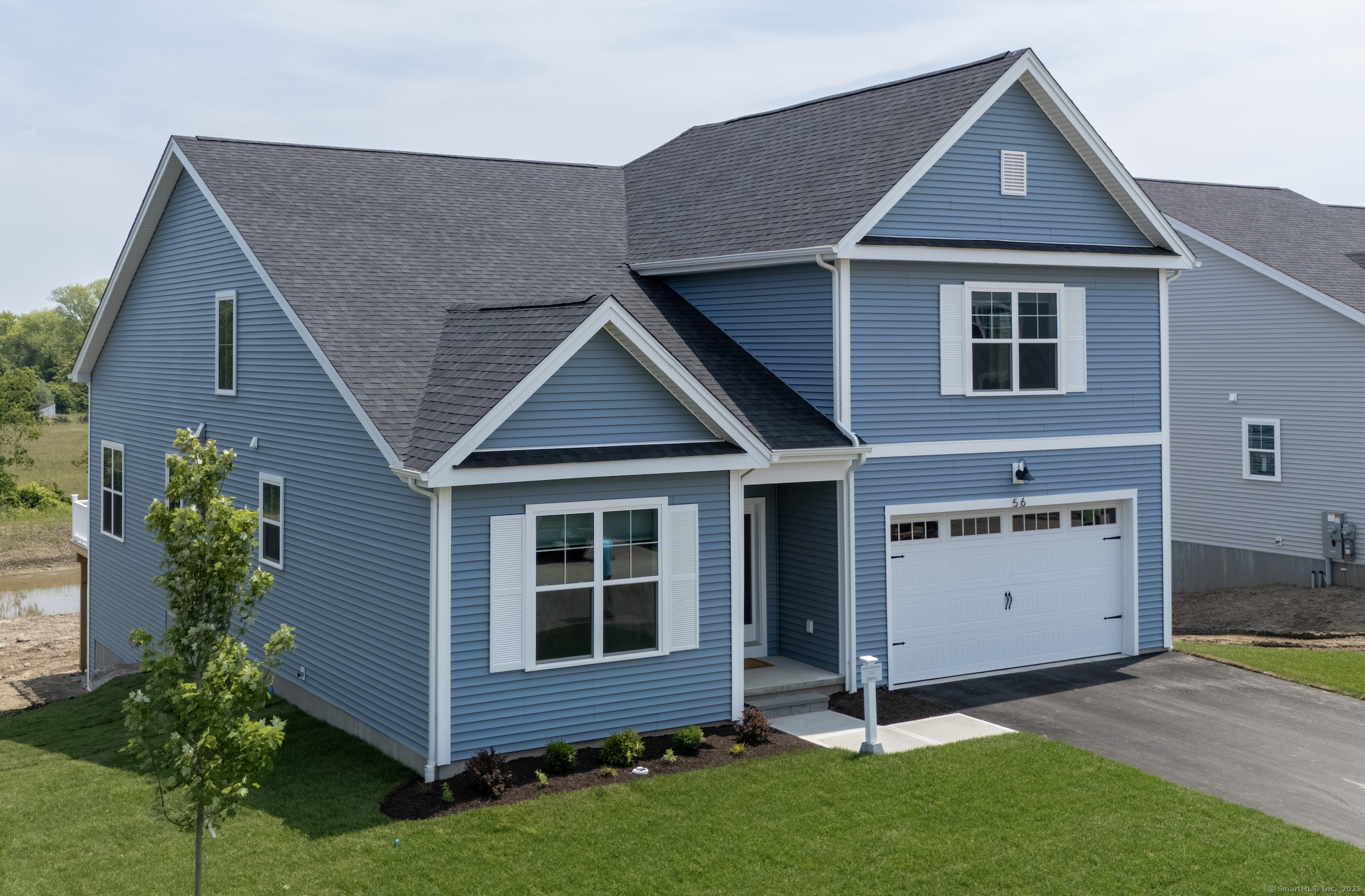 56 Summertime Circle Pawcatuck, CT 06379 - Photo 1 of 1 a front view of a house with a yard
