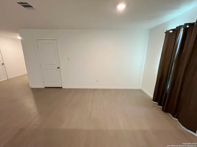 a kitchen with granite countertop white cabinets and black appliances