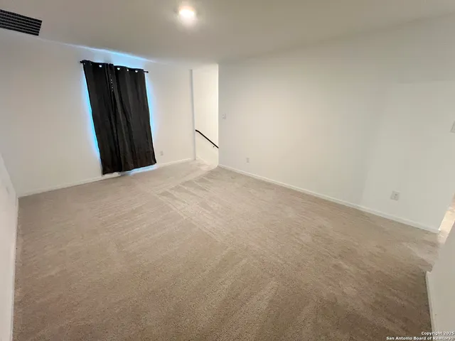 a view of an empty room and a window