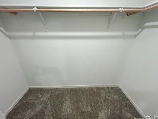 a bathroom with a sink a toilet a mirror and shower