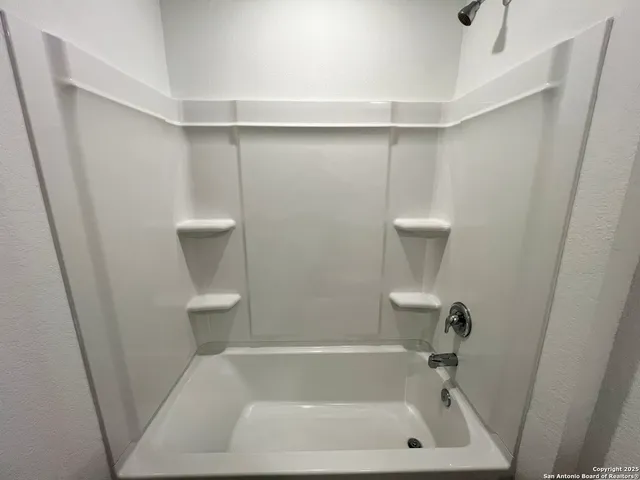 a view of bedroom with a sink and closet