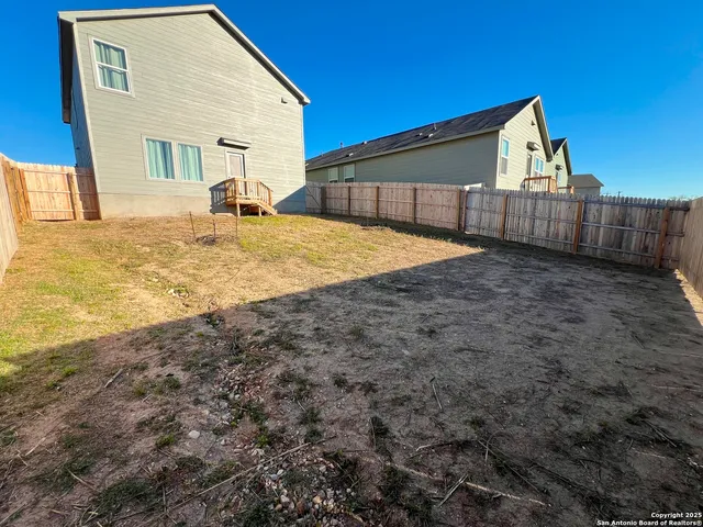 a view of a swimming pool with outdoor seating and kitchen