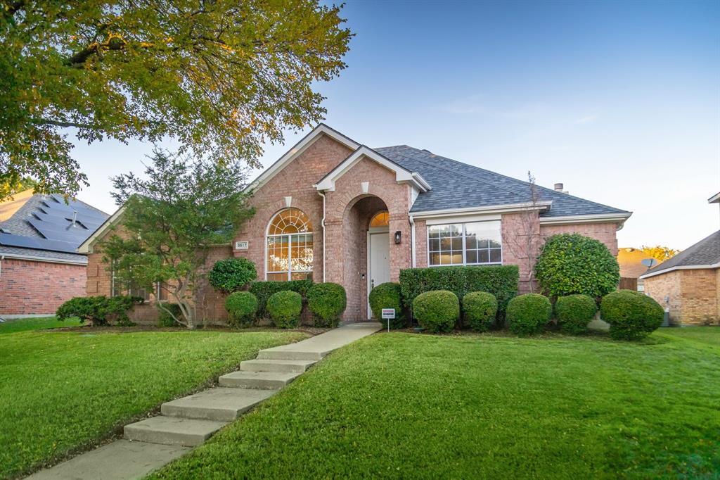 a front view of house with yard and green space
