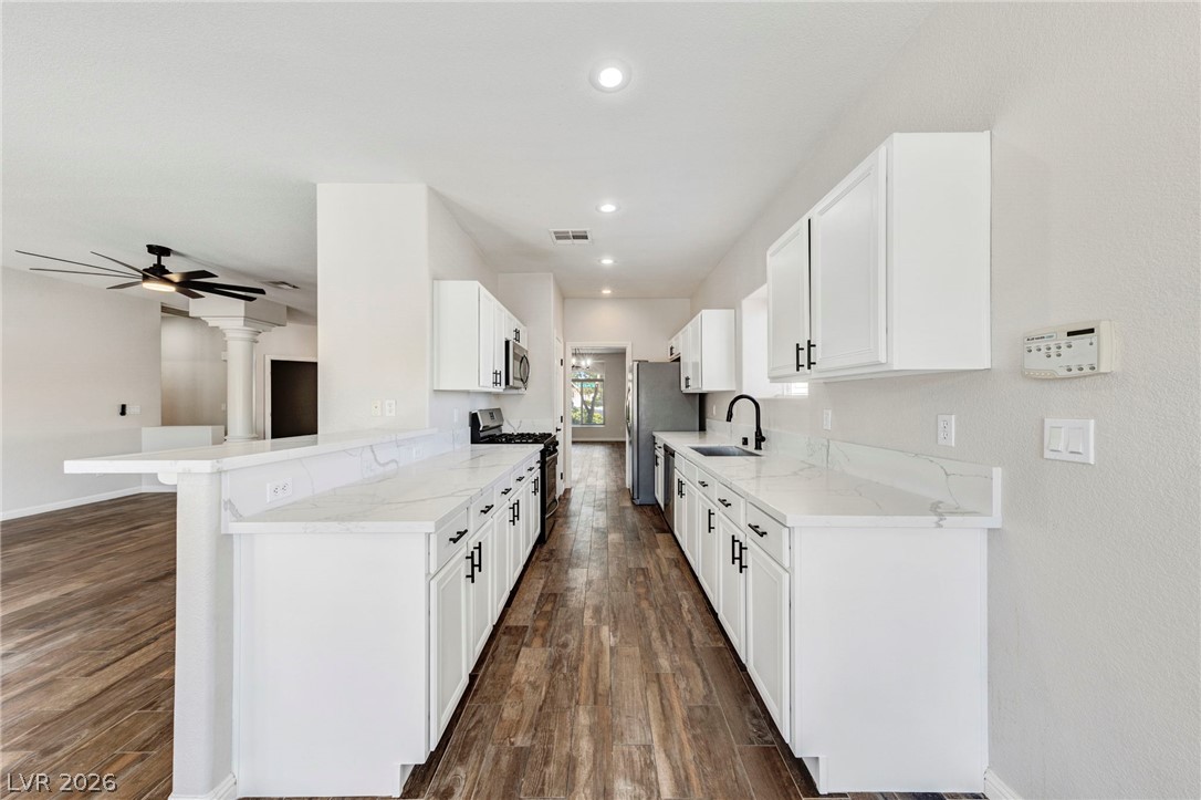740 Aldo Rae Court, Unit NONE Henderson, NV 89052 - Photo 12 of 35 Streamlined kitchen design with abundant counter space and rich wood-look flooring.