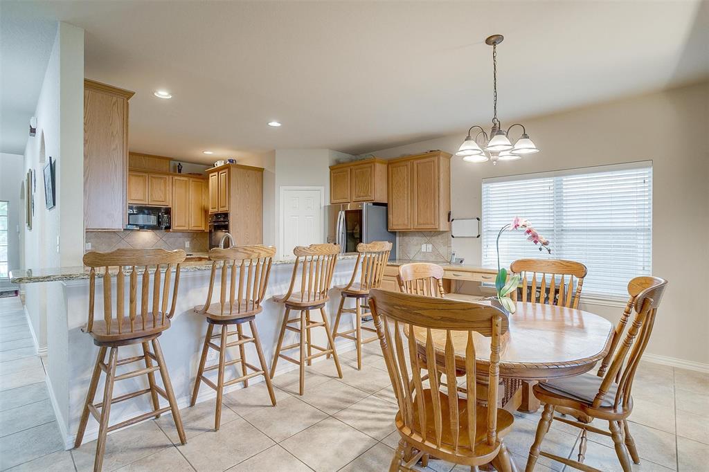2536 Glenn Ranch Drive Burleson, TX 76028 - Photo 11 of 40 a view of a dining room with furniture and chandelier