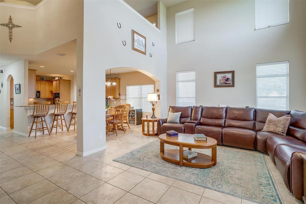 2536 Glenn Ranch Drive Burleson, TX 76028 - Photo 16 of 40 a living room with furniture a dining table and a large window