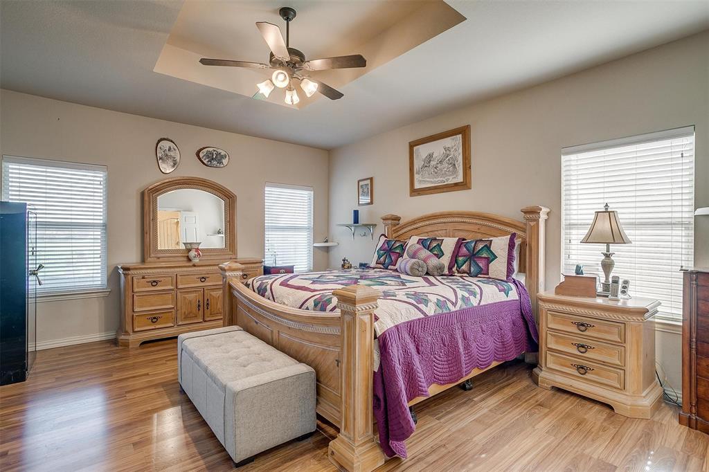 2536 Glenn Ranch Drive Burleson, TX 76028 - Photo 18 of 40 a bedroom with a bed and wooden floors