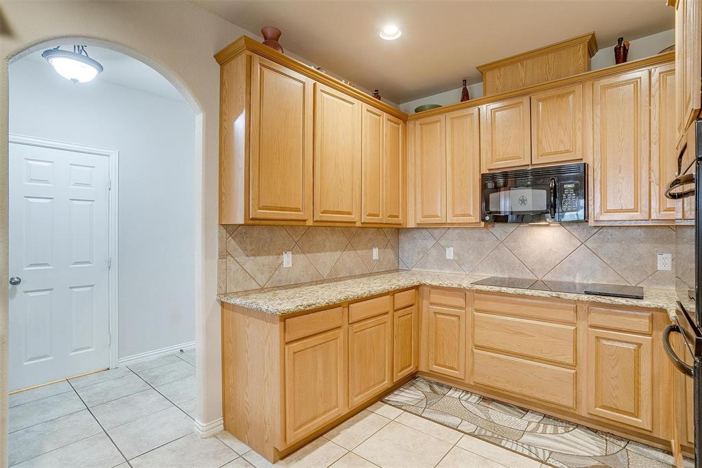 2536 Glenn Ranch Drive Burleson, TX 76028 - Photo 7 of 40 a kitchen with granite countertop a sink and cabinets
