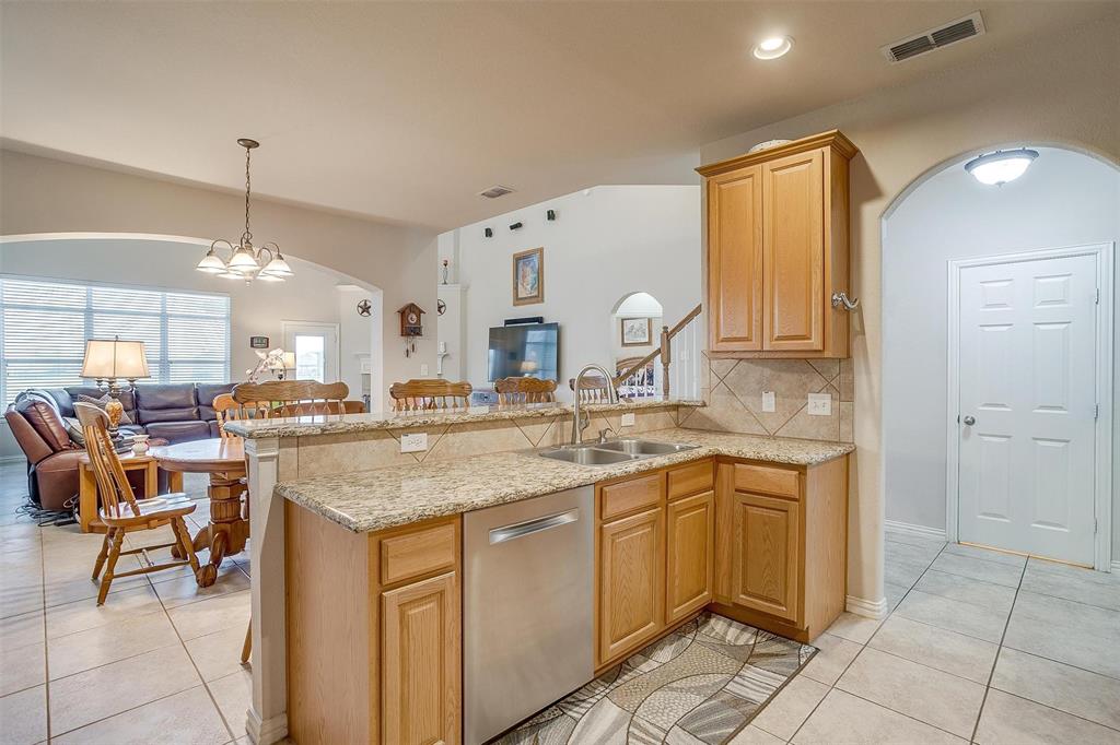 2536 Glenn Ranch Drive Burleson, TX 76028 - Photo 8 of 40 a kitchen with a sink and chairs