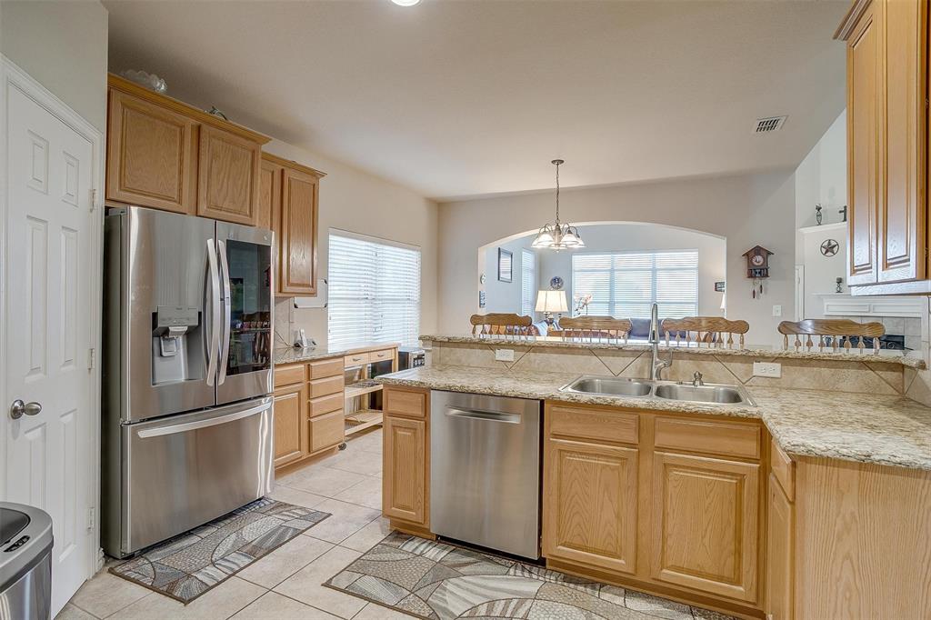 2536 Glenn Ranch Drive Burleson, TX 76028 - Photo 9 of 40 a kitchen with white cabinets and white appliances