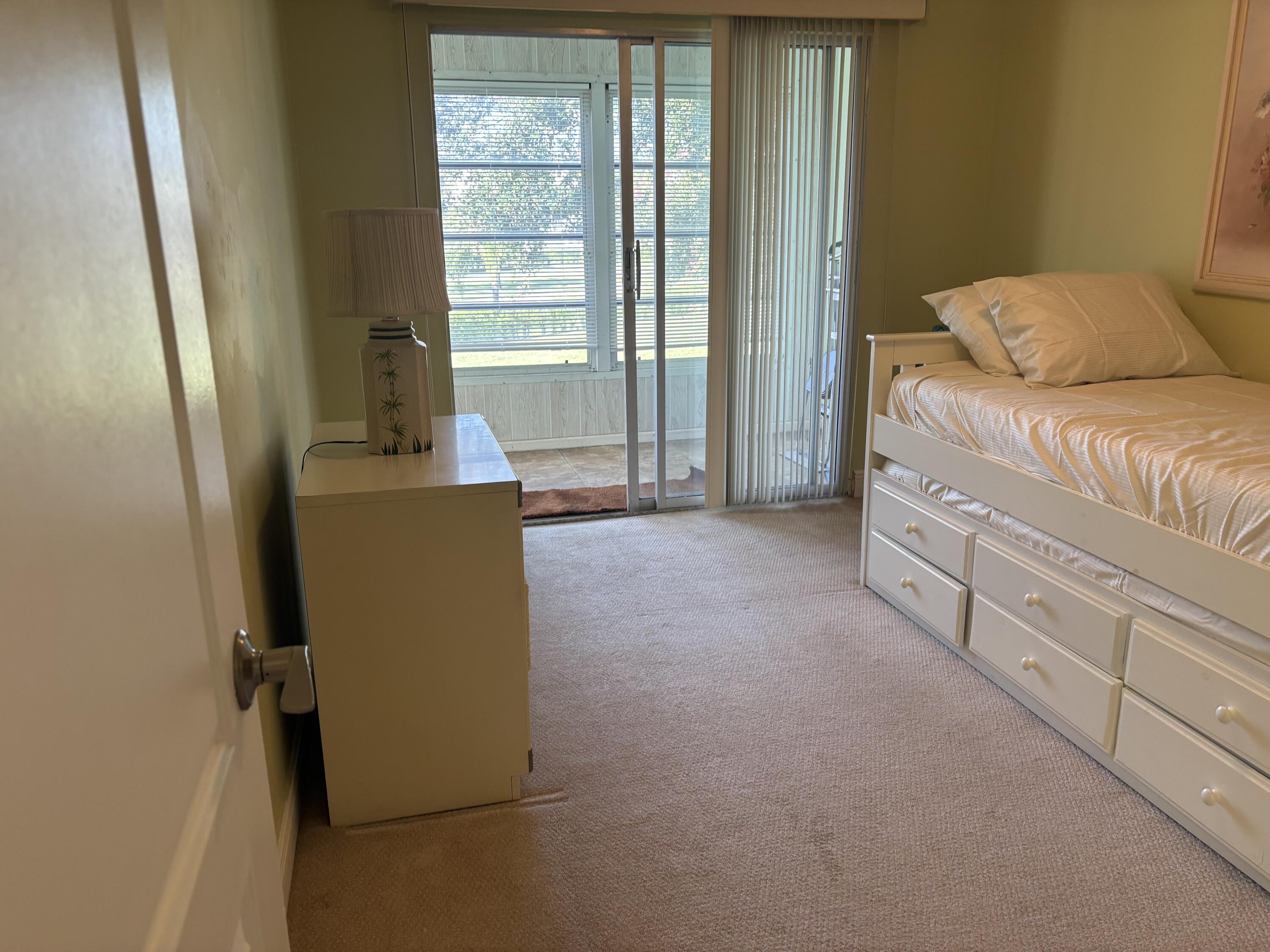 154 Preston F, Unit 154D Boca Raton, FL 33434 - Photo 12 of 17 a living room with furniture and a window