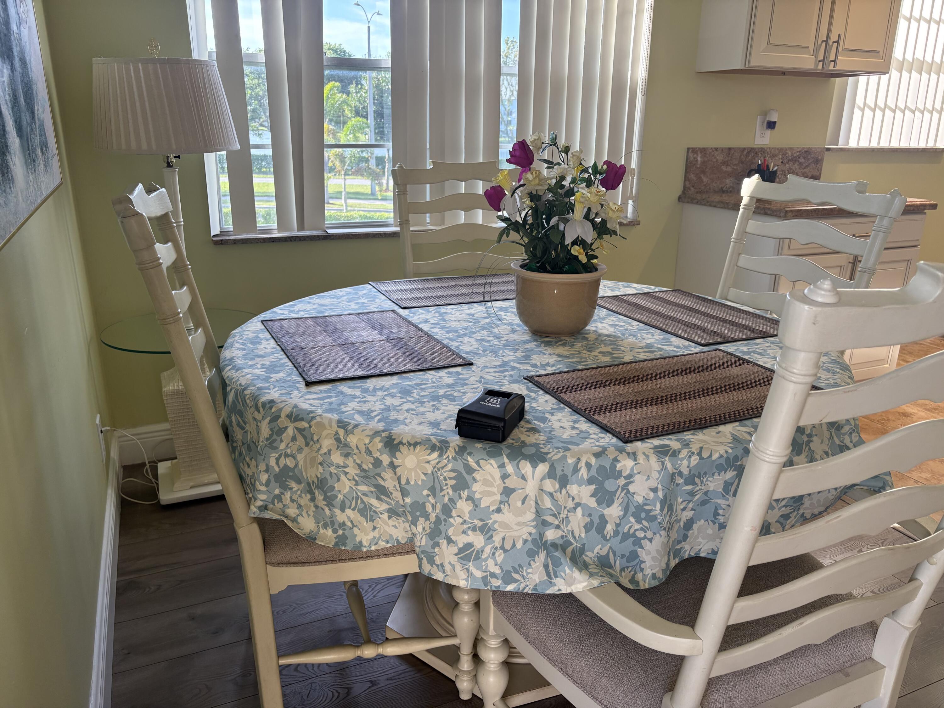 154 Preston F, Unit 154D Boca Raton, FL 33434 - Photo 4 of 17 a view of a dining room with furniture and window