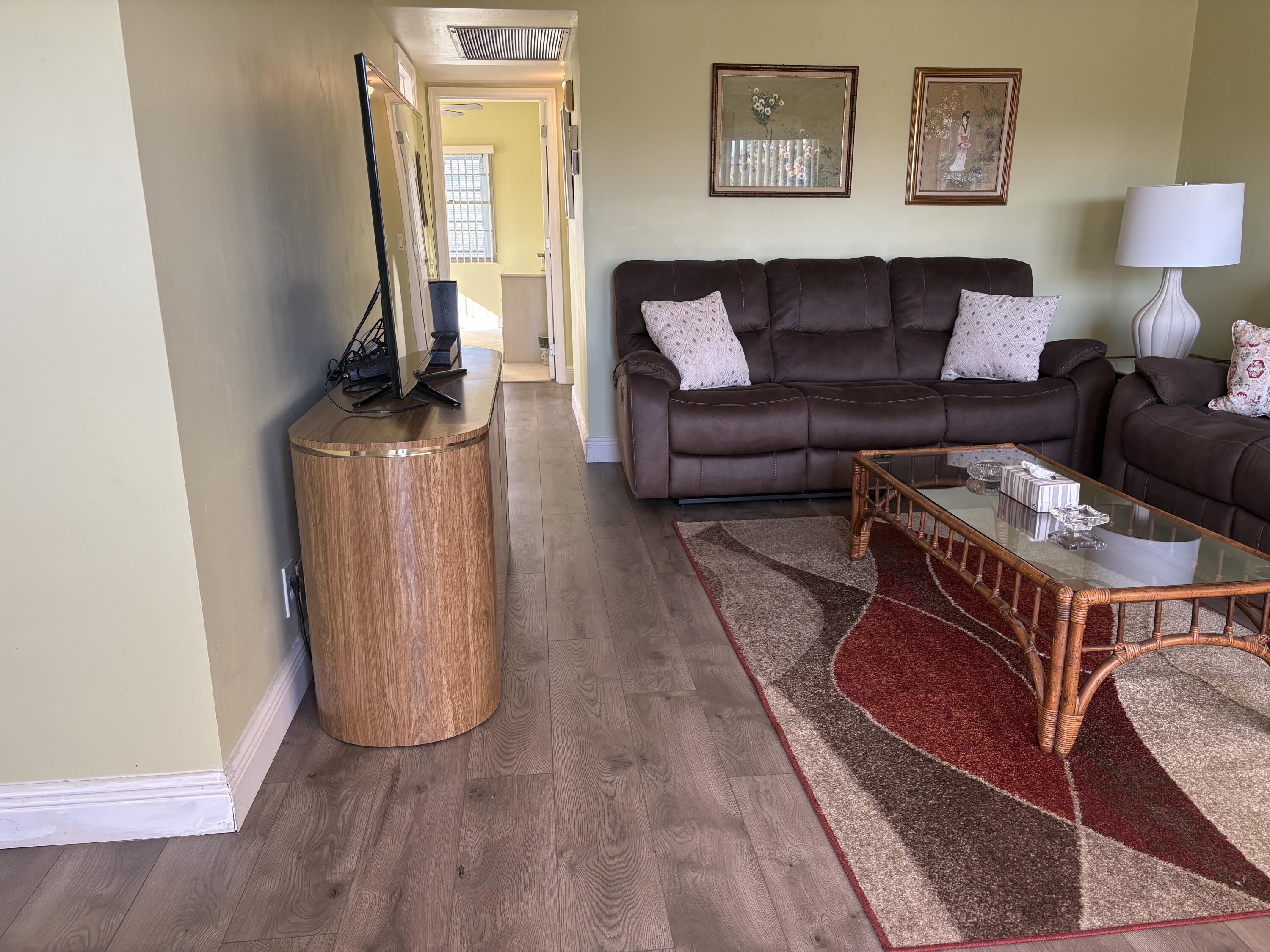 154 Preston F, Unit 154D Boca Raton, FL 33434 - Photo 5 of 17 a living room with furniture and a fireplace